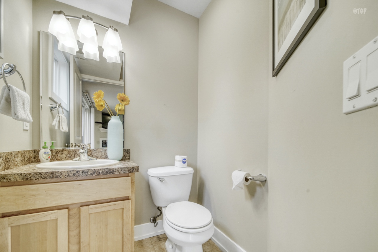 The bathroom in the 1 bed 1.5 bath Northern Lights Condo Resort Unit 13 is bright.