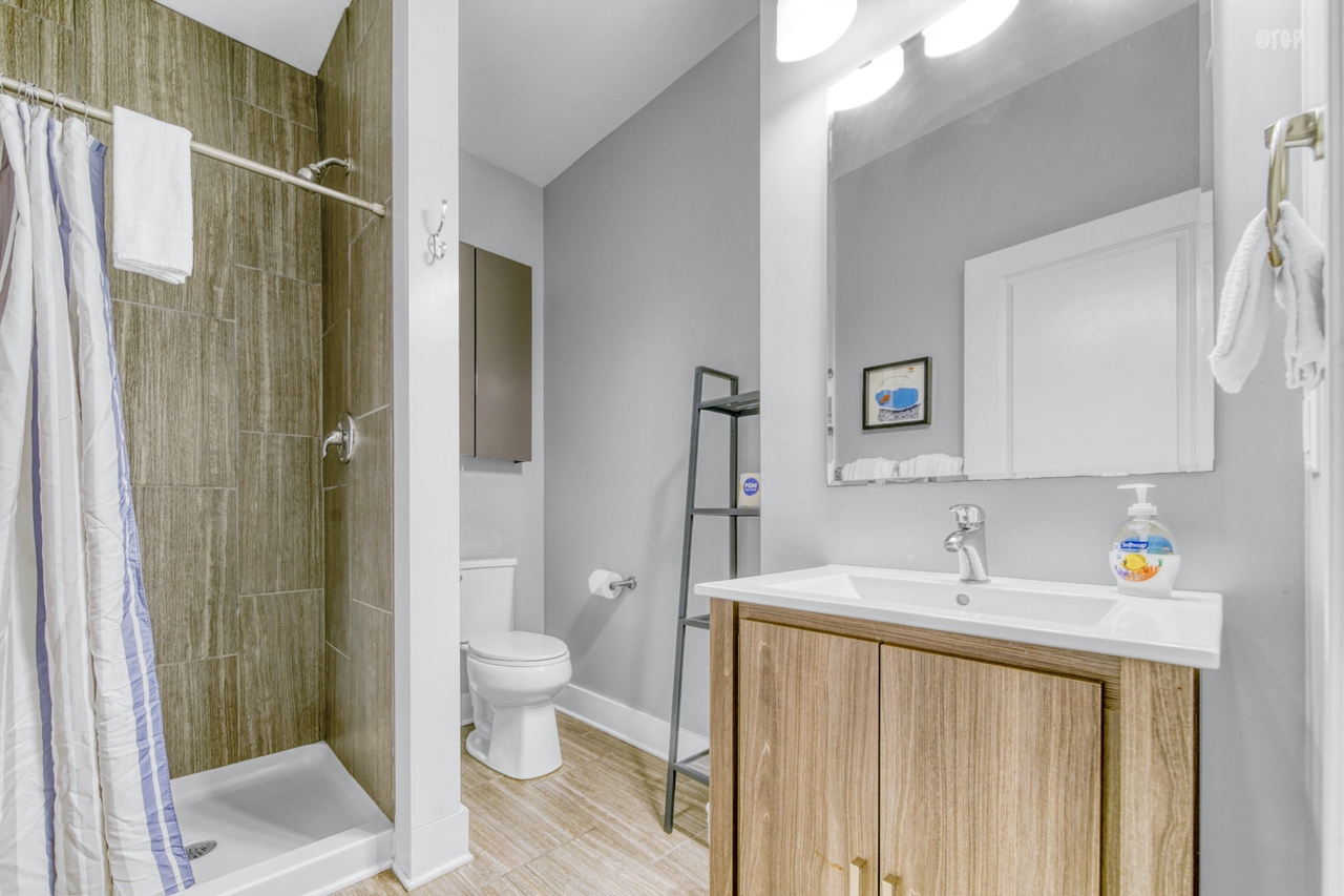 The bathroom in Northern Lights Condo Resort Unit 25 features modern furniture and textures.