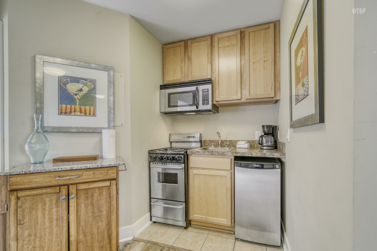 The kitchen unit in Northern Lights Condo Resort Unit 13 includes a stove and dishwasher.